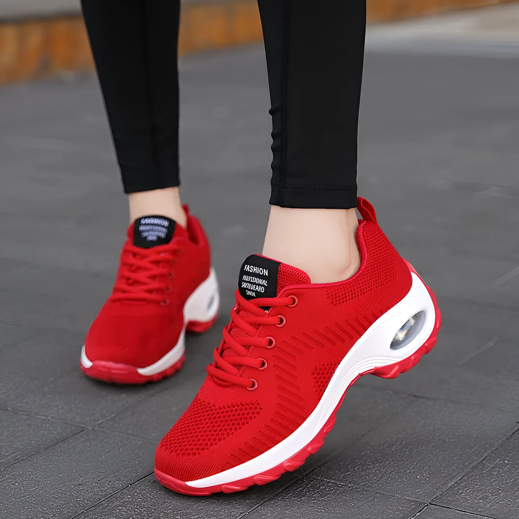 Women's black mesh sneakers with front lace-up and round toe, showing mid-heel profile