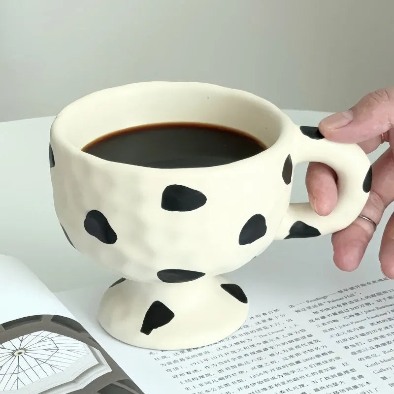 Hand-pinched irregular ceramic mug with modern minimalist design in solid colour
