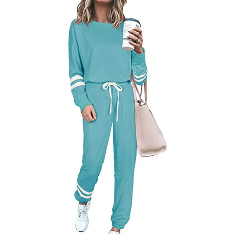 Women's loose-fitting casual suit set in a solid colour, comprising a long-sleeve top and matching trousers.