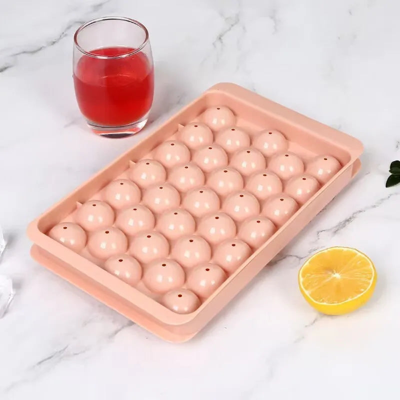 Blue silicone ice cube tray with lid showing 33 round ice moulds