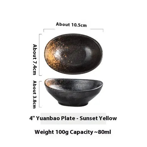Oval Japanese ceramic dipping bowl with underglaze pattern on a wooden table.