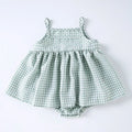 Baby girl in Korean style plaid princess sling romper dress in light green on white background