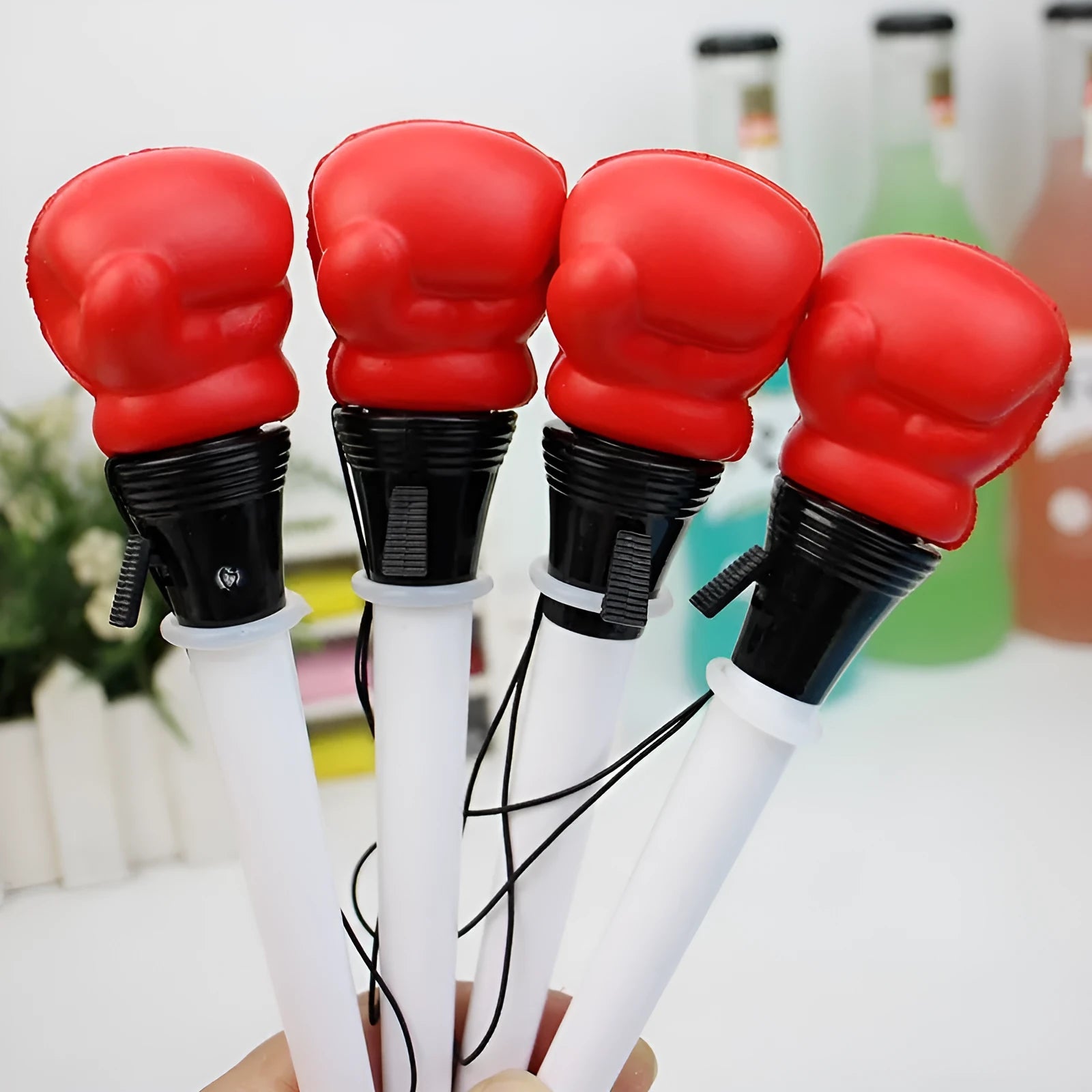 Four pressure relief boxing press ejection pens with black refills and 0.7mm bullet tips