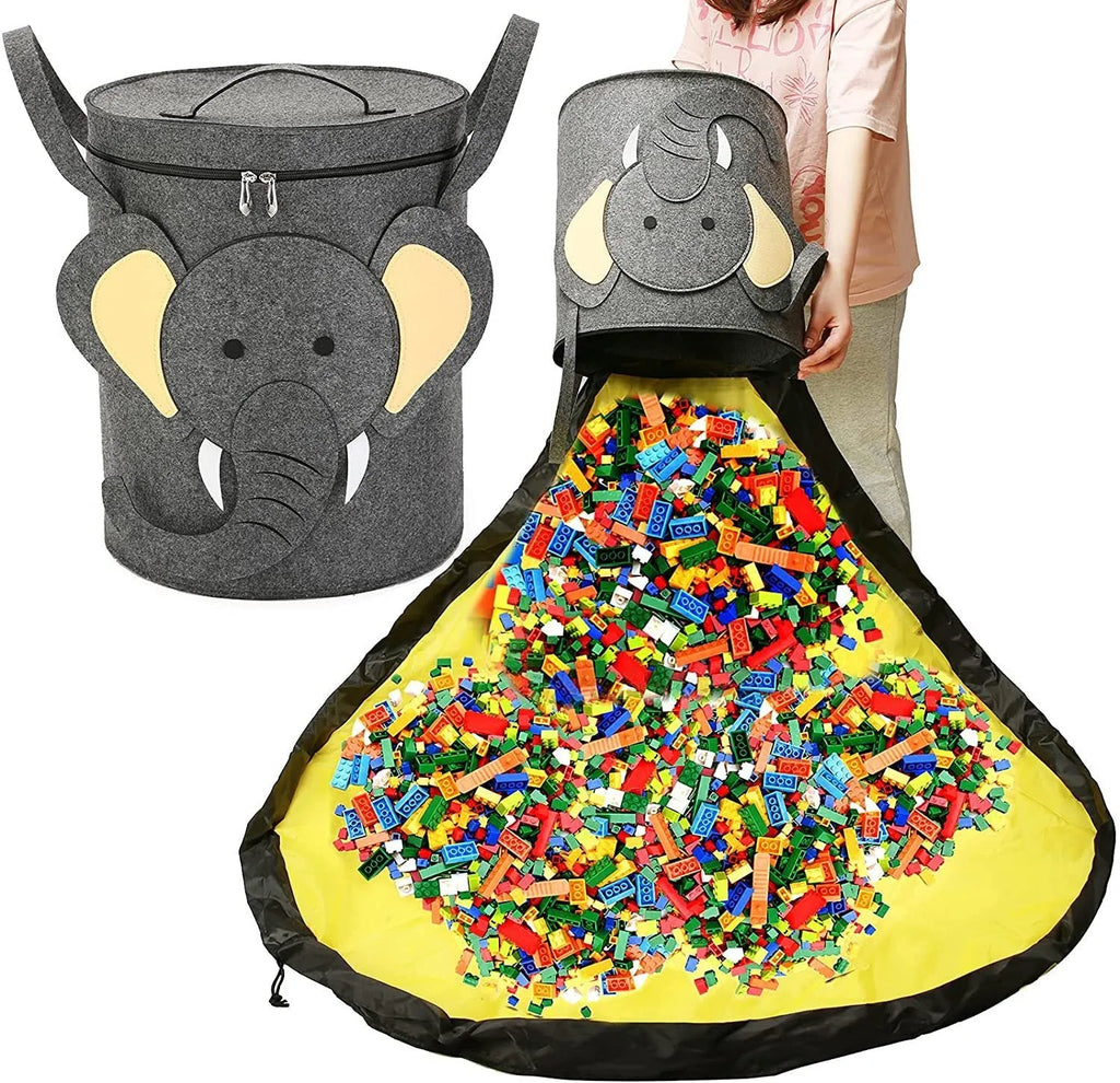 Green cube-shaped felt storage bag with pull rope lying flat as a play mat.