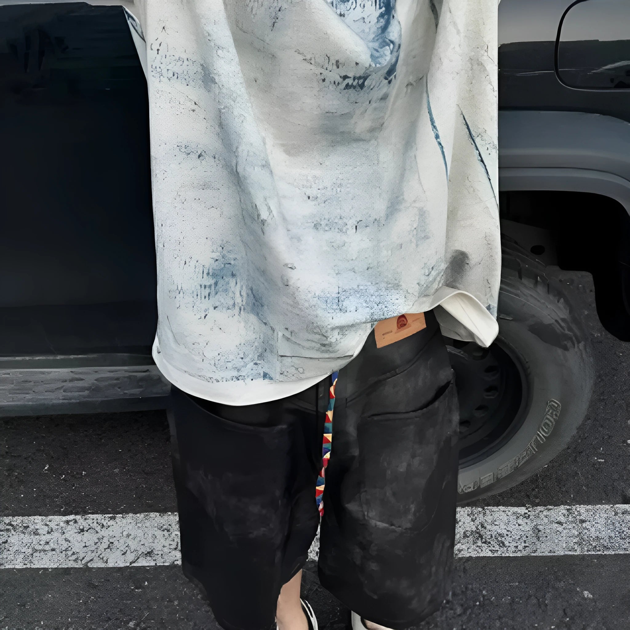 Korean style loose fit T-shirt with a full printed tie dye and dirty painting design on a solid colour background.