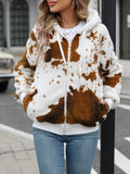 Yellow and brown cow print hooded cardigan jacket with a full front zip on a model.
