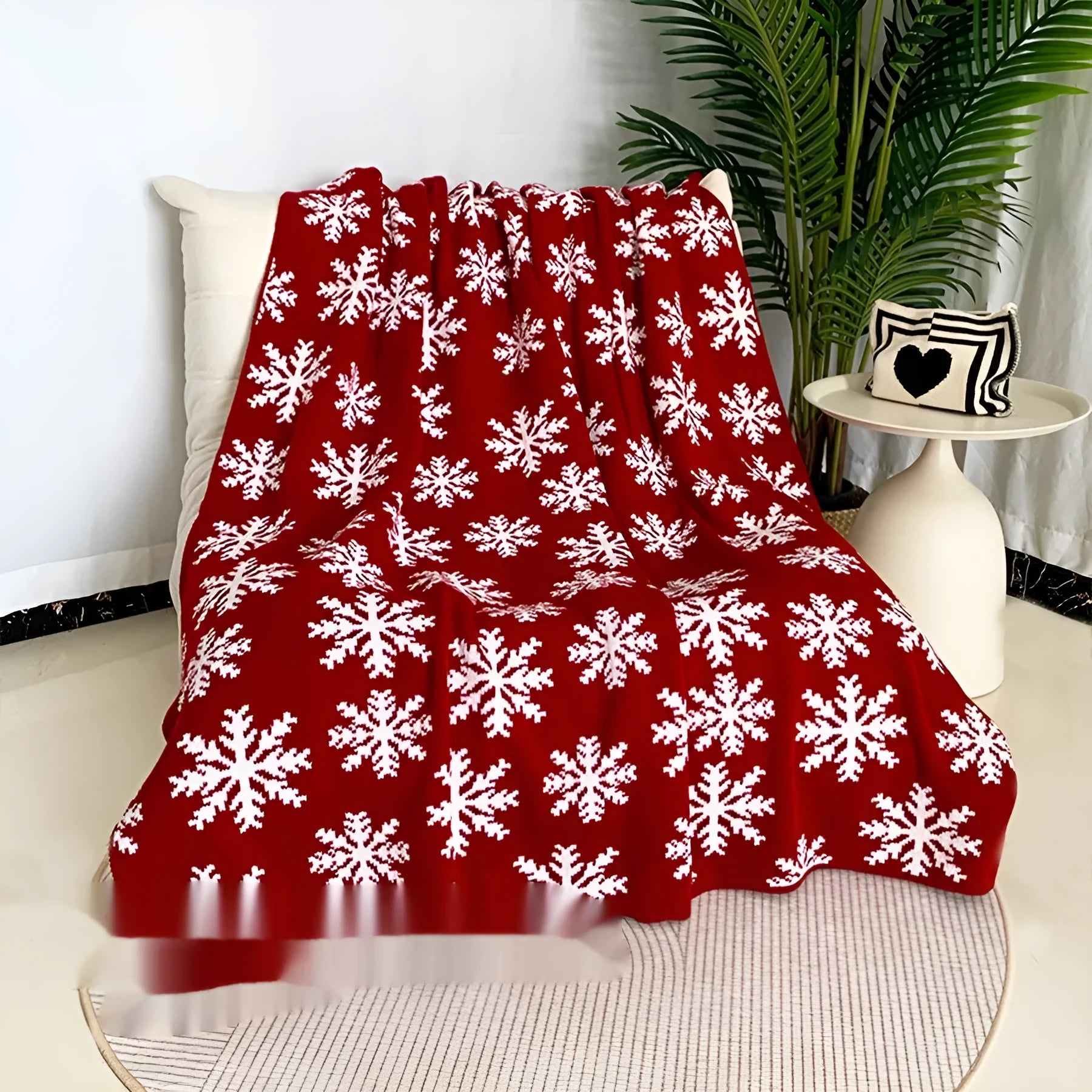 Personalised Christmas acrylic blanket with reindeer or snowflake pattern on a sofa
