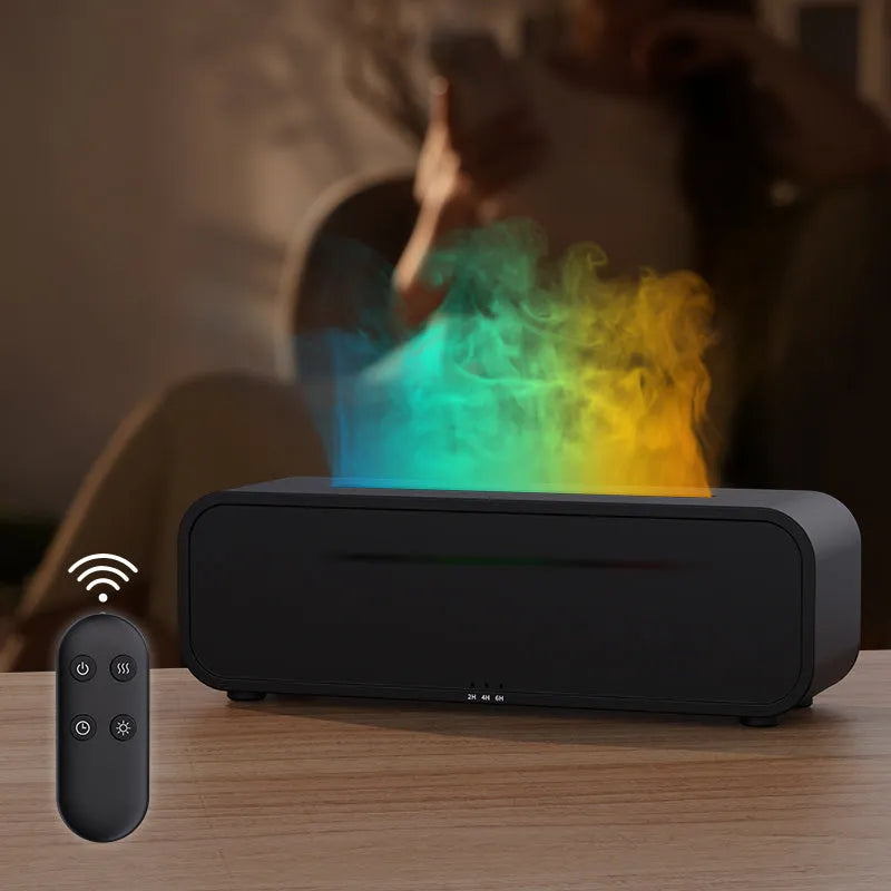Black and white USB aroma diffuser with remote control on a desk, showing colour-changing LED lights.