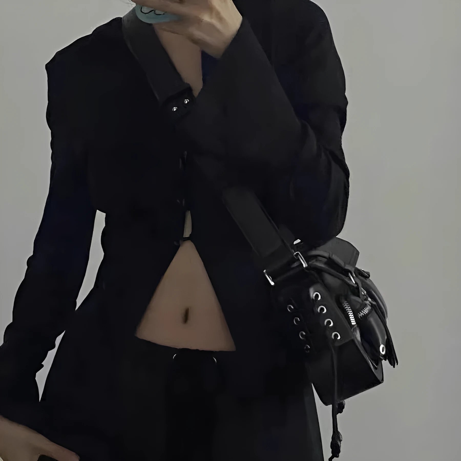 Black PU leather underarm baguette bag with adjustable shoulder strap shown in crossbody position