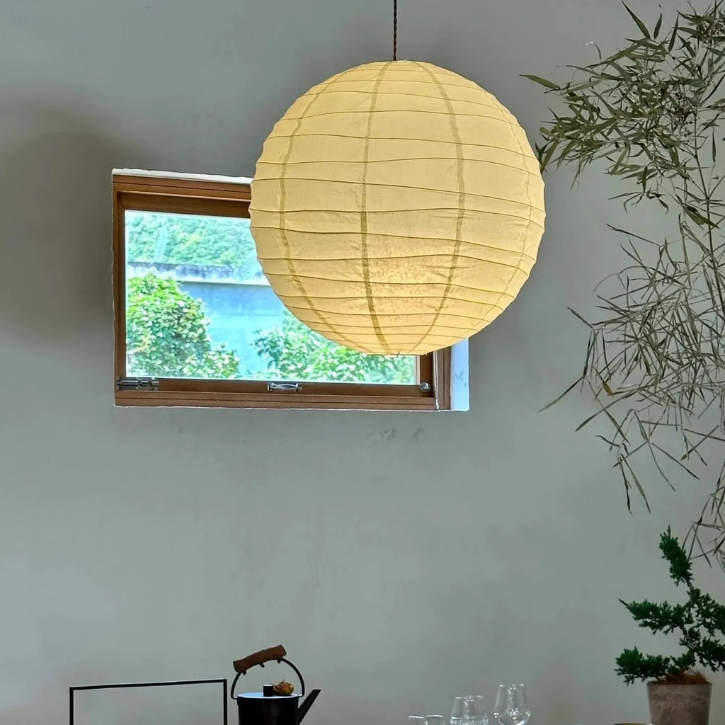 Japanese rice paper pendant chandelier with soft white shade in a living room setting.