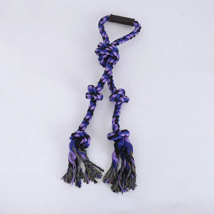 Blue and yellow woven cotton rope dog tug toy with a handle, shown next to a large dog.