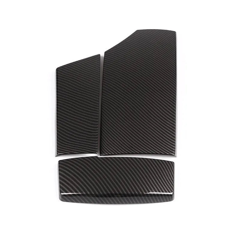 Three black ABS car armrest box covers with a shiny carbon fibre diagonal weave pattern.