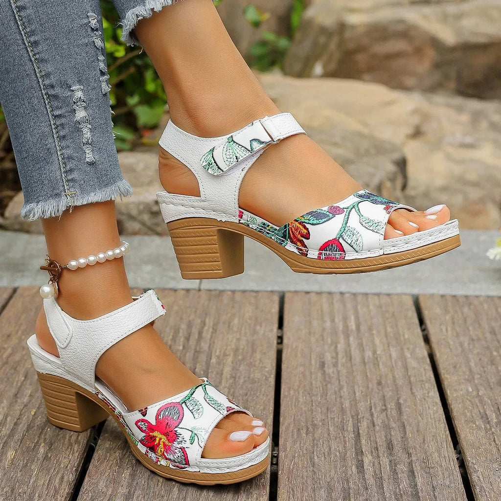 White women's high heel sandals with a Velcro buckle strap and a rubber sole.