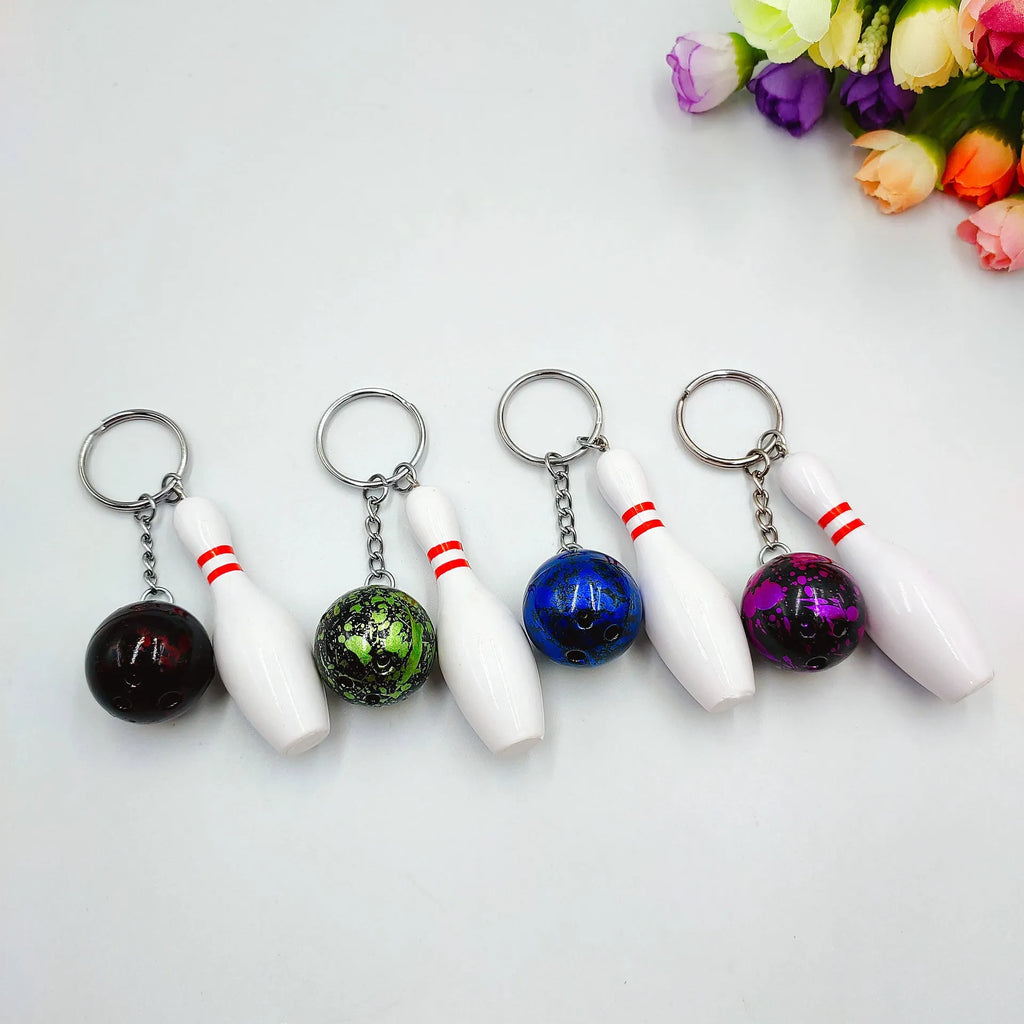 Mini bowling pin simulation keychain pendant in blue, made from PVC and metal on a key ring.