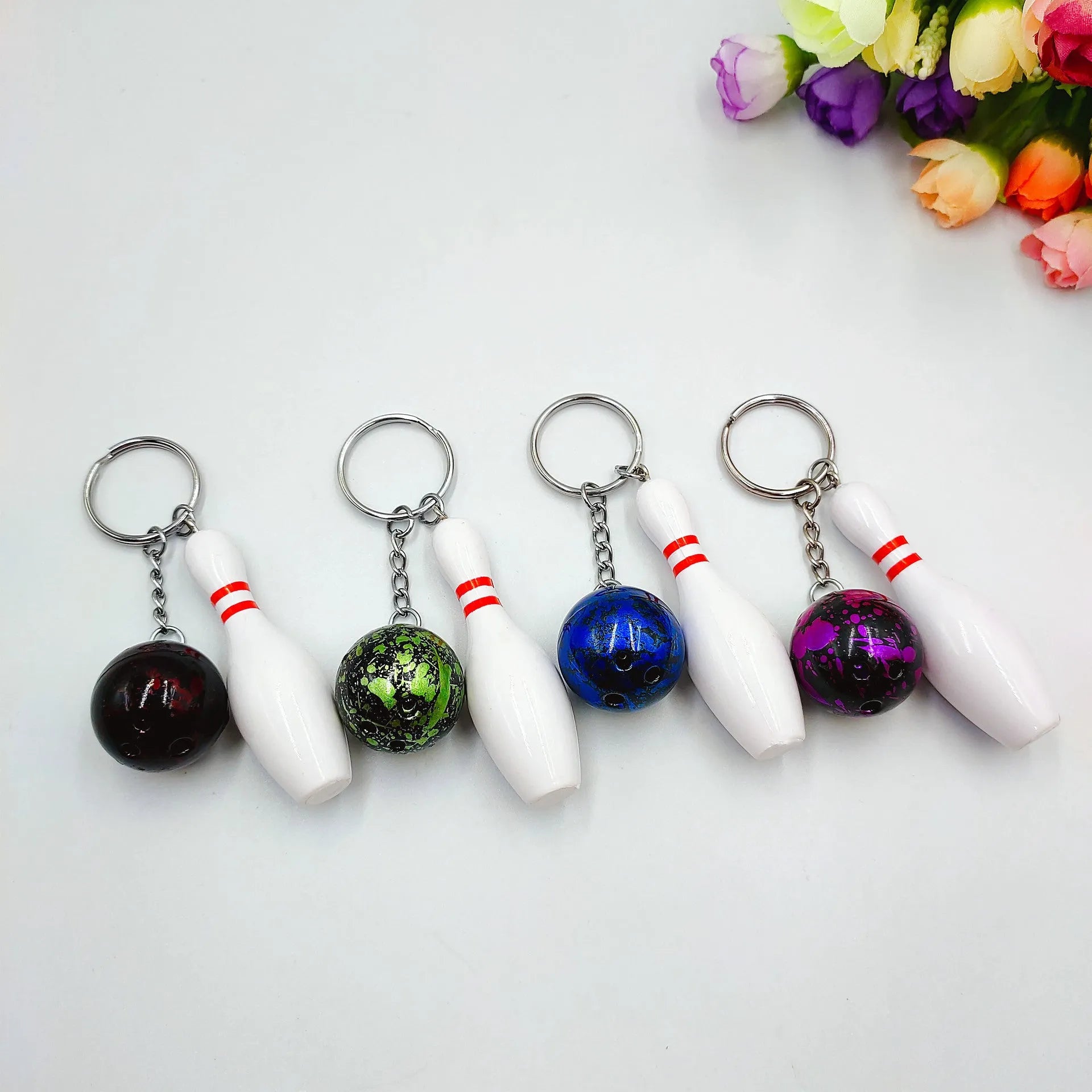 Mini bowling pin simulation keychain pendant in blue, made from PVC and metal on a key ring.