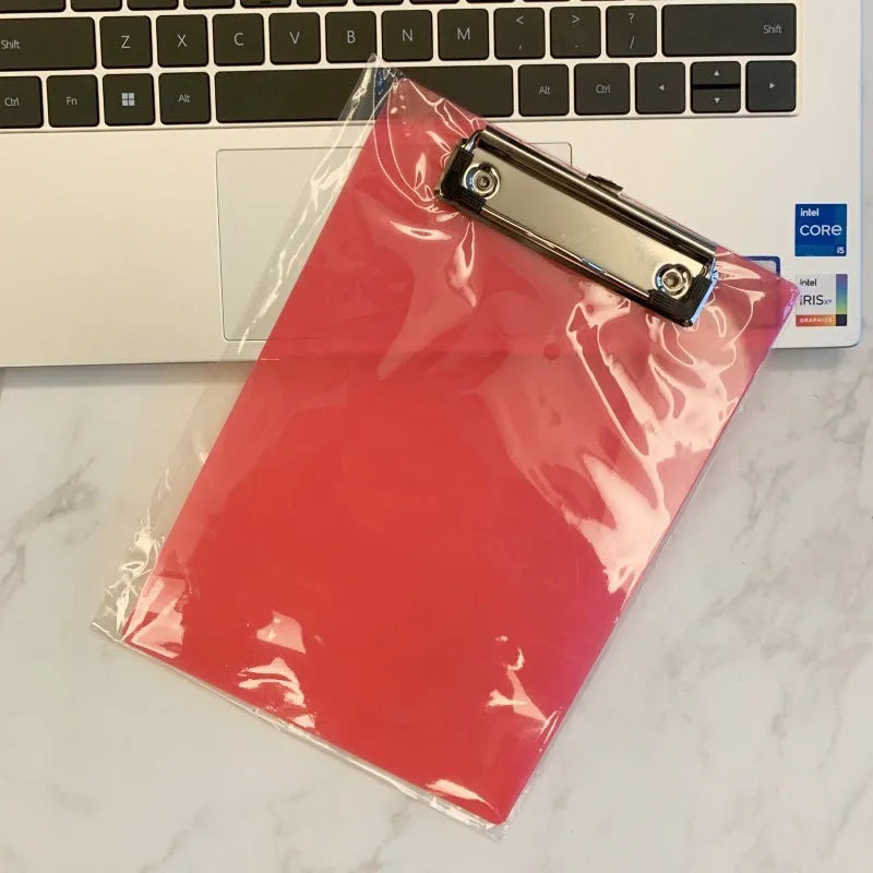 Transparent A4 plastic writing board pad with a silver metal clip, shown in blue colour.