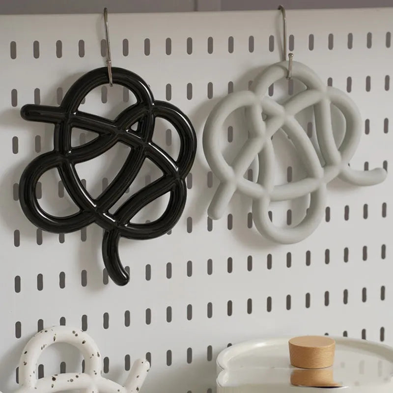 Ceramic heat proof mat with irregular shape and bend and hook design