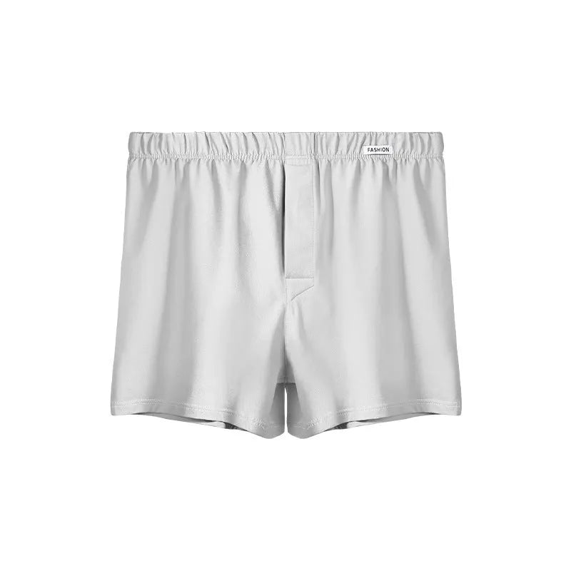 Men's loose-fitting cotton boxer shorts in solid colours like gold and green.