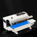 Mini handheld plastic bag sealing machine with integrated date printer on a kitchen counter.