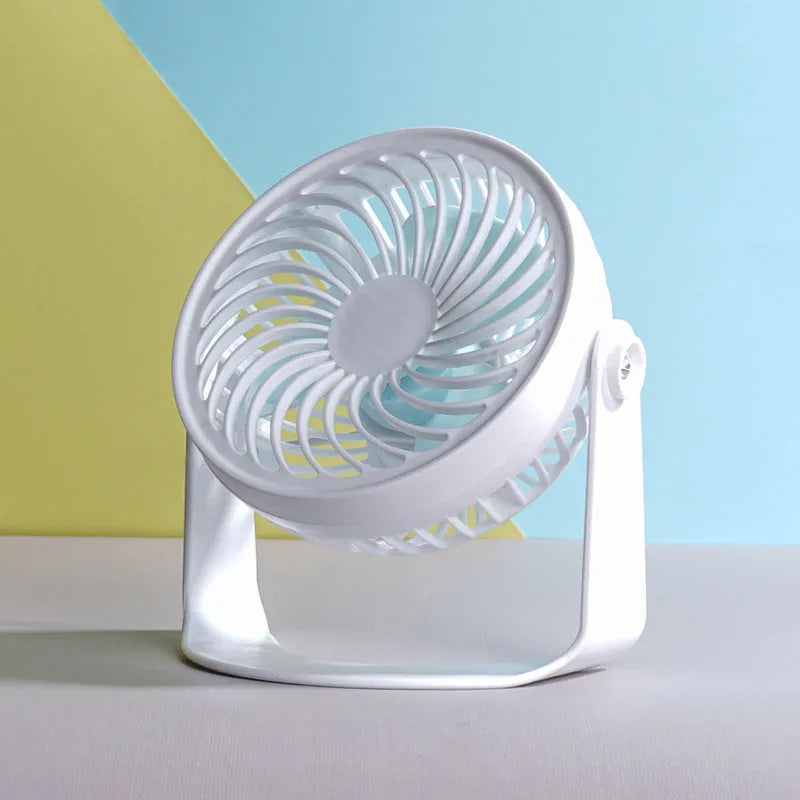 White USB desk fan with clip attachment and three blades, shown on a desk.