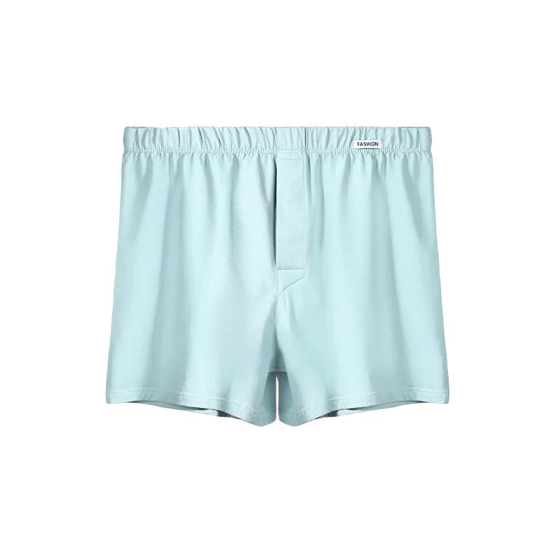 Men's loose-fitting cotton boxer shorts in solid colours like gold and green.