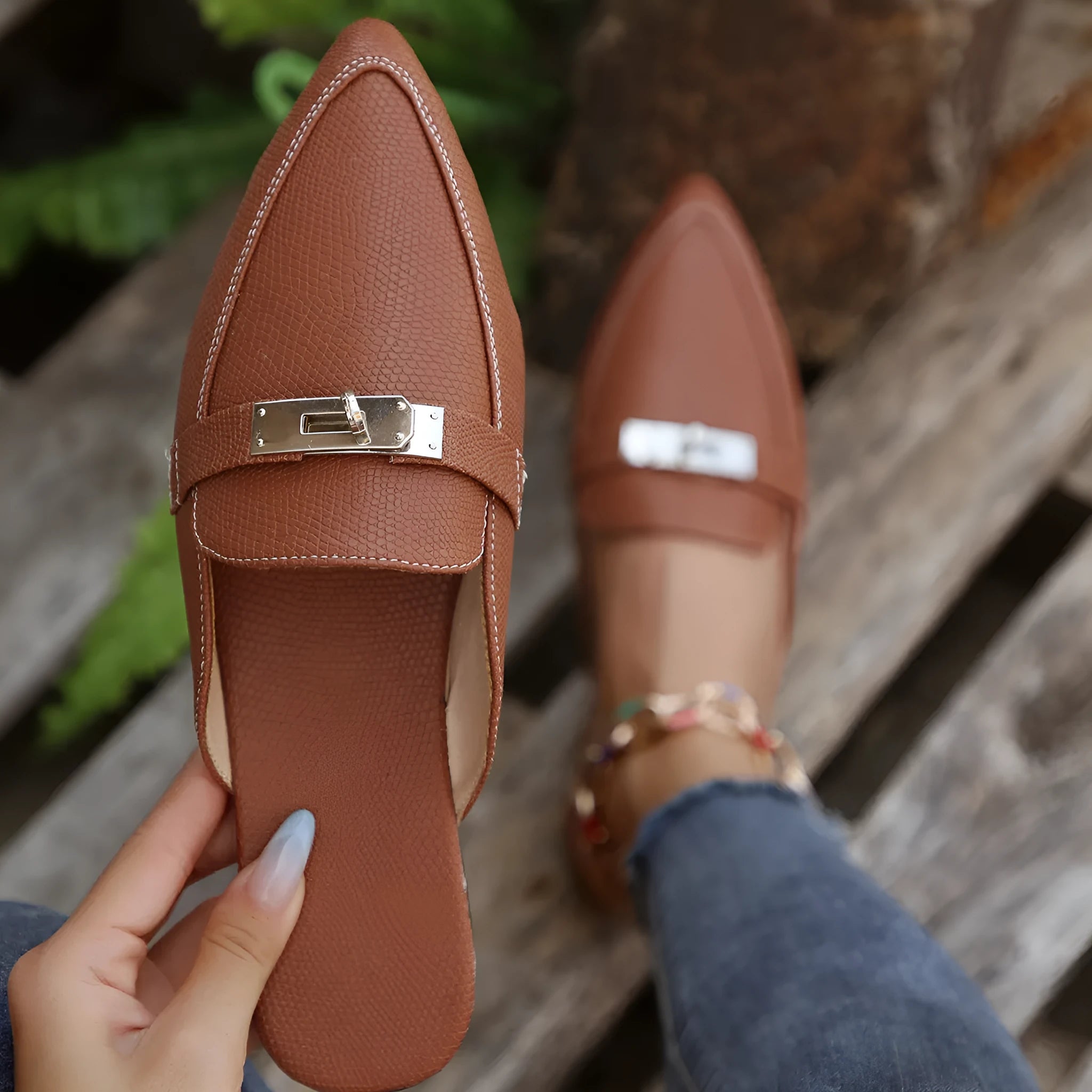 Light brown women's pointed-toe casual slippers with a low heel and rubber sole.