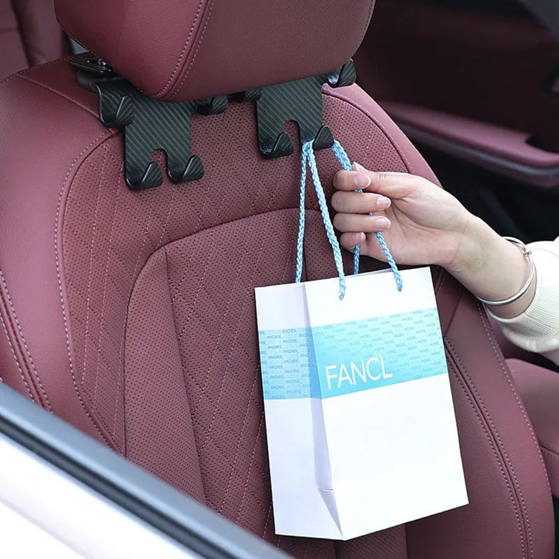 Black ABS plastic car hook and mobile phone holder for rear seat back storage.