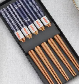 Set of five pairs of bamboo chopsticks with colourful Japanese lucky cat pattern design.