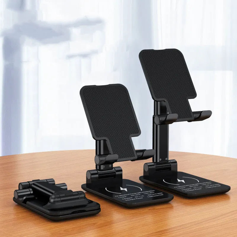 Black wireless charging phone desk stand holding a mobile phone at an angle.