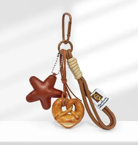 Handmade soda bread style handbag pendant charm with cartoon design and brown strap