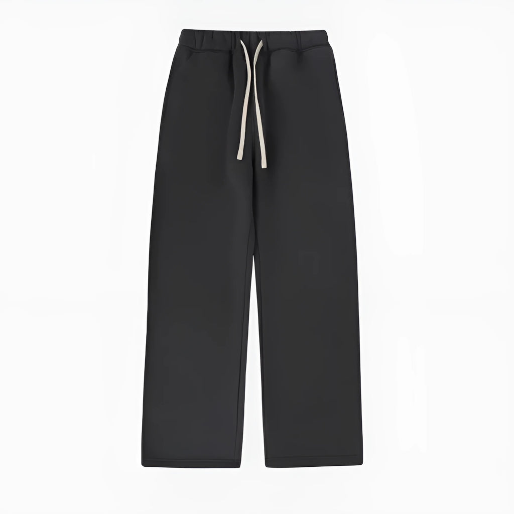 Man wearing black fleece-lined loose-fit sweatpants with an elastic drawstring waist