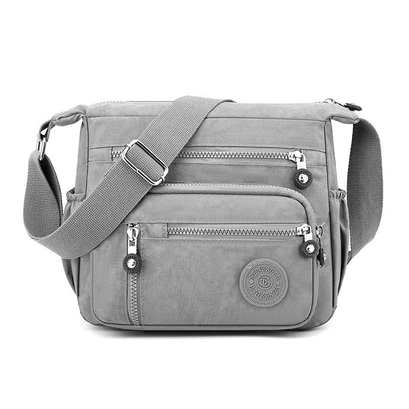 Soft nylon messenger shoulder bag in a choice of five colours including black and blue.