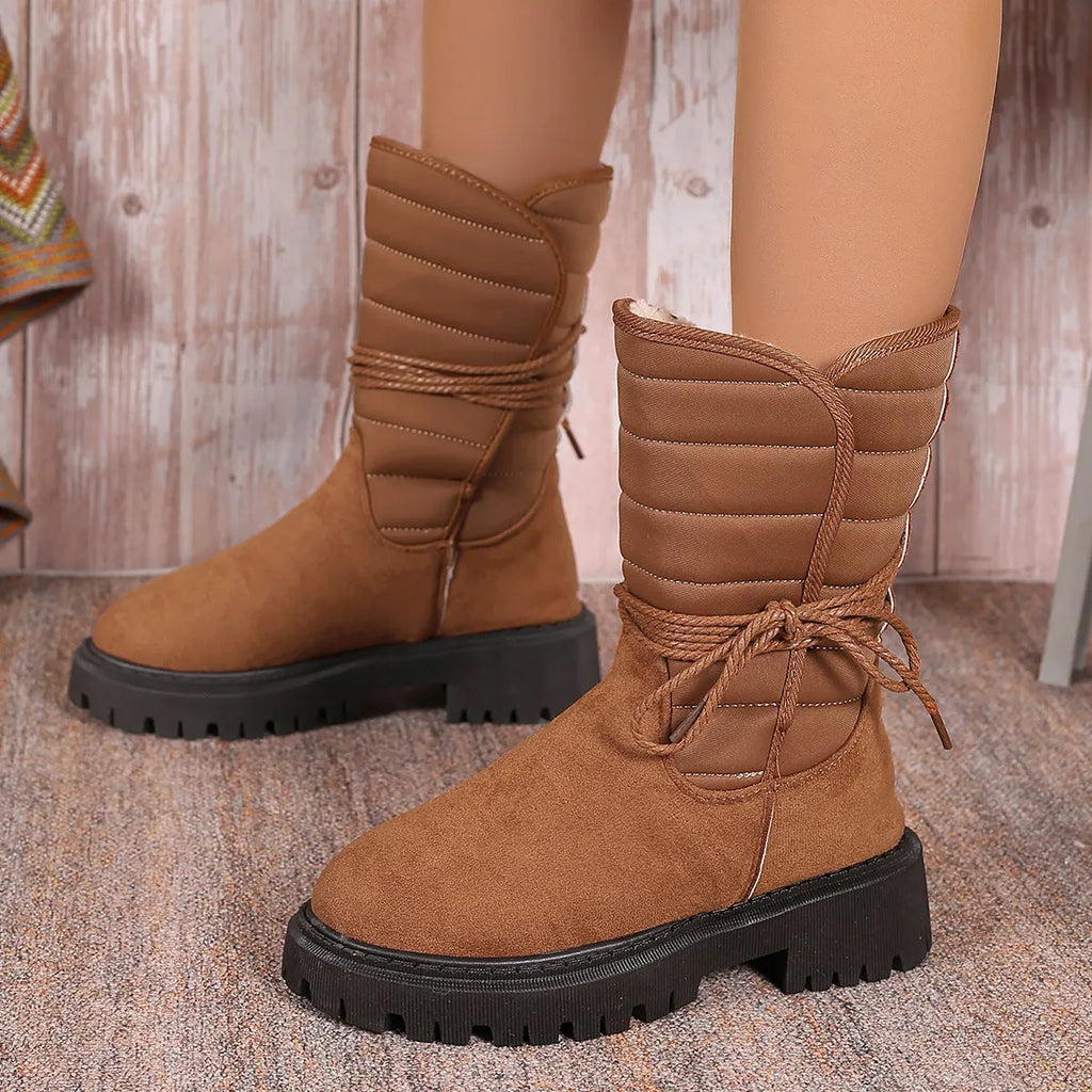 Women's black suede snow boots with chunky heel, lace-up design, and fleece lining
