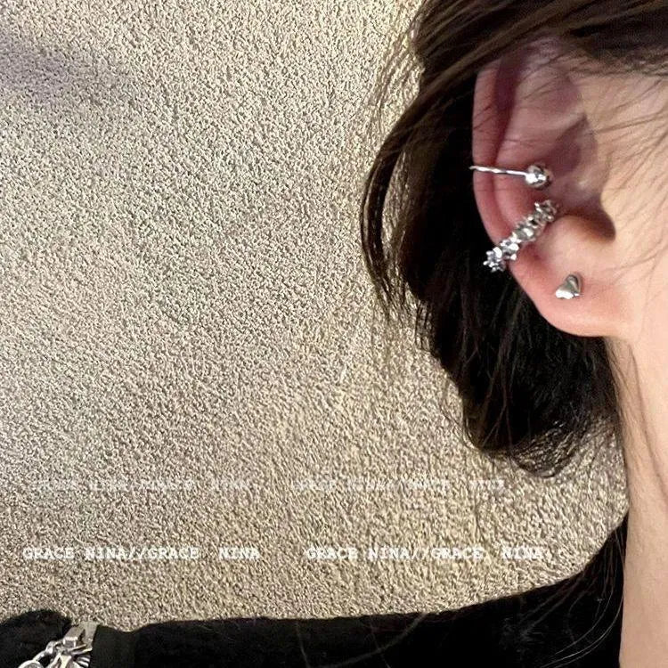 A pair of silver geometric irregular-shaped earrings with a frosted finish and clip-on fastenings.