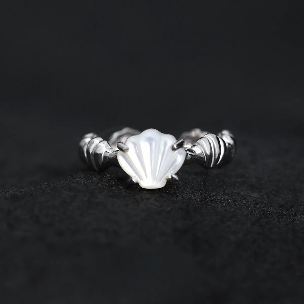 Women's adjustable silver ring with sculpted shell design and tiger eye stone in gold finishes