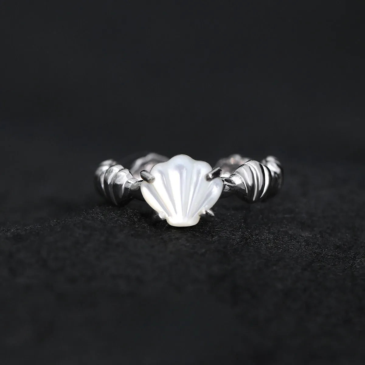 Women's adjustable silver ring with sculpted shell design and tiger eye stone in gold finishes