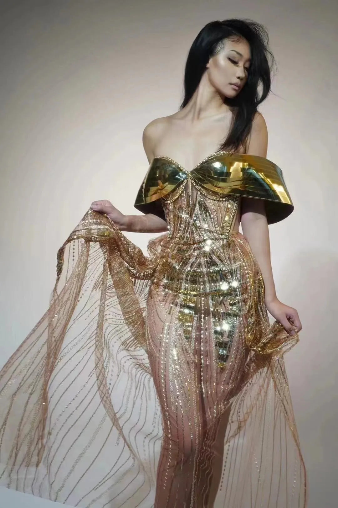 Gold sequined strapless dress with tulle skirt and thigh-high split, shown on mannequin