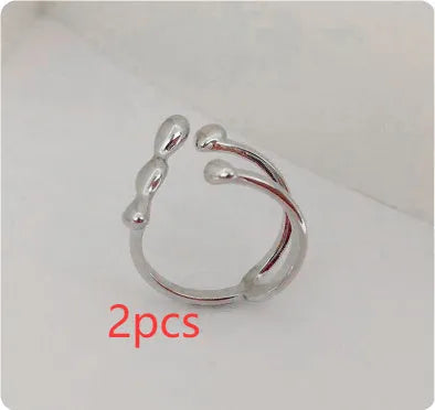 Adjustable brass opening ring with circular sphere element in gold or silver finish