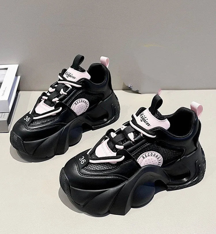 Women's pink sneakers with thick sole, cross ankle straps and mesh lining.