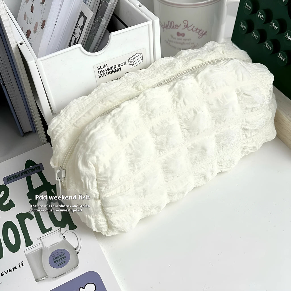 Cream puff fabric pencil case in beige or black colour with zippered closure