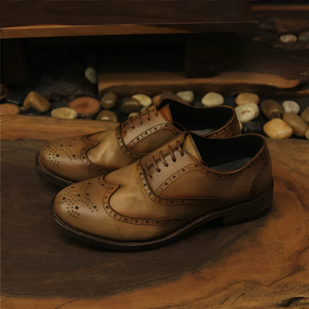 Light brown men's vintage distressed leather shoes with engraved detailing, round toe, and lace-up front.