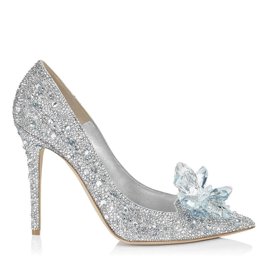 Gold women's high heel with pointed toe, rhinestones, and a stiletto heel on a white background.