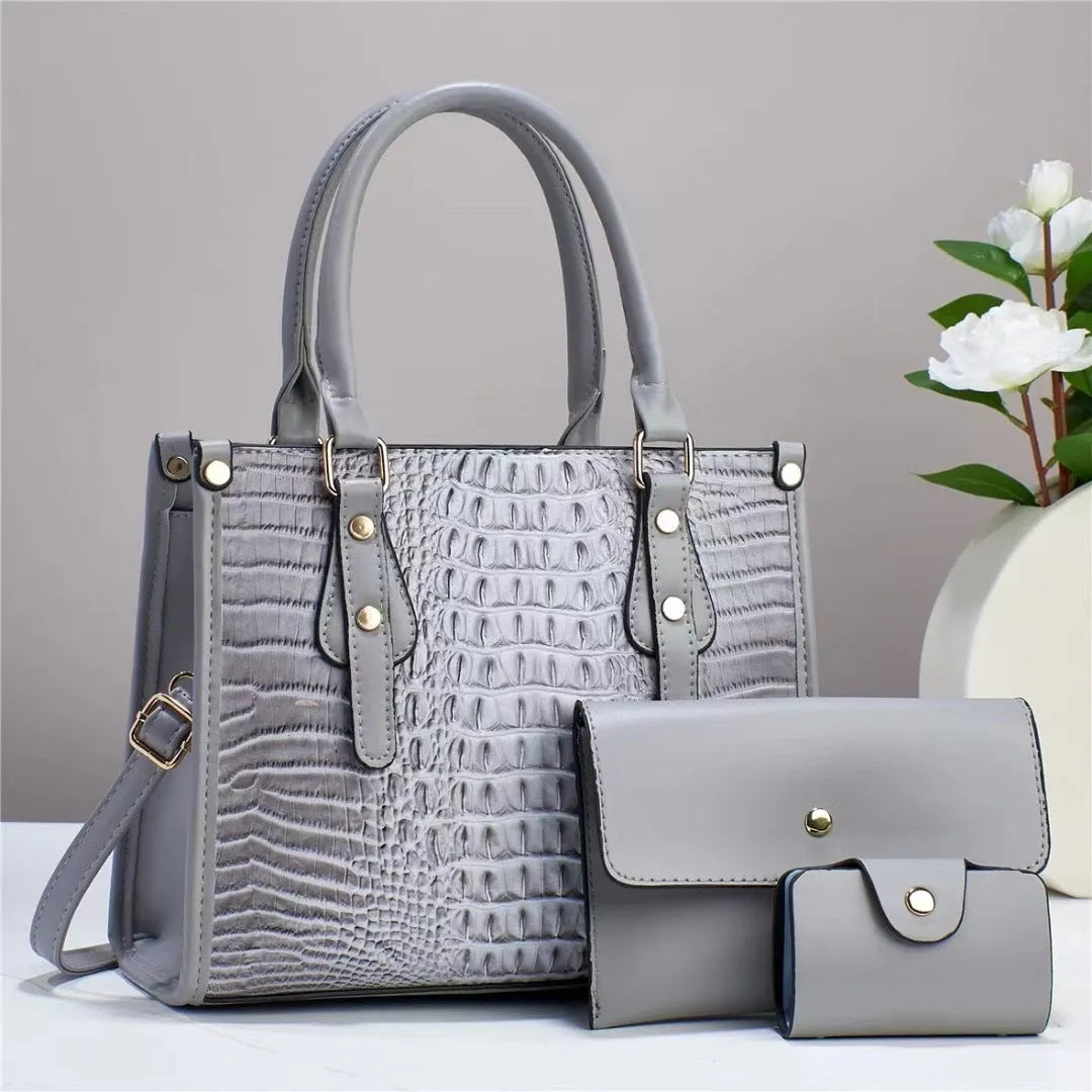 Minimalist textured PU three-piece bag set showing crossbody bag, wallet, and card holder in a contrast colour.