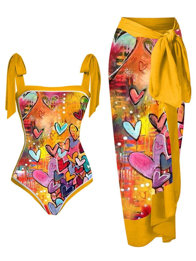 Women's floral print two-piece swimsuit with a blue chiffon skirt laid flat.