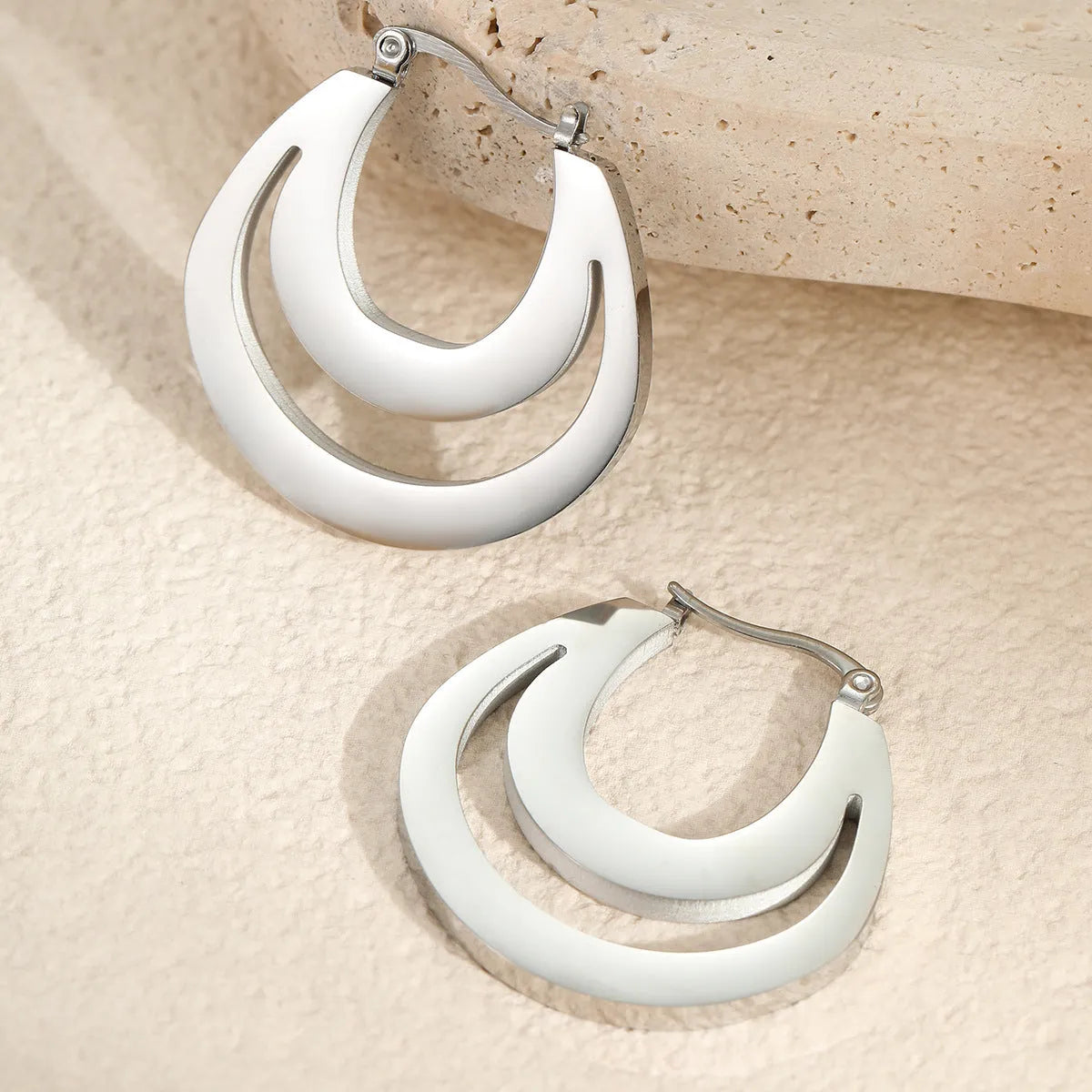 Geometric French earrings with circular ring elements in 18K gold plated metallic finish