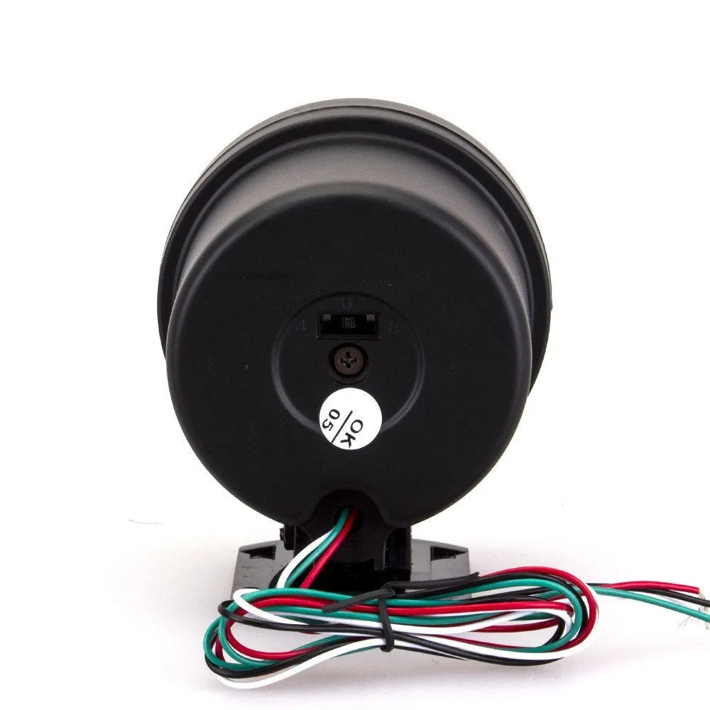 Black plastic universal automotive tachometer with blue light pointer and RPM scale.