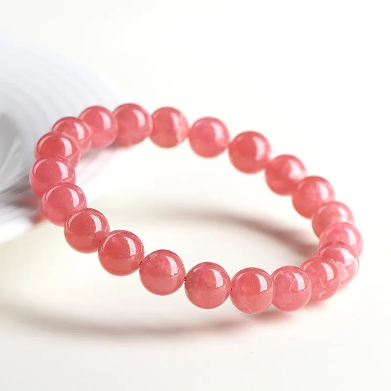 Women's red rhodochrosite crystal bracelet with geometric design and longevity lock fastening