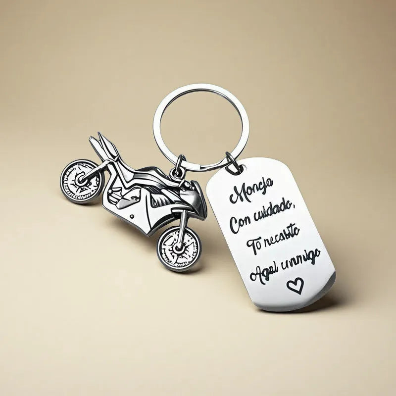 Stainless steel key ring with detailed motorcycle design on metal surface