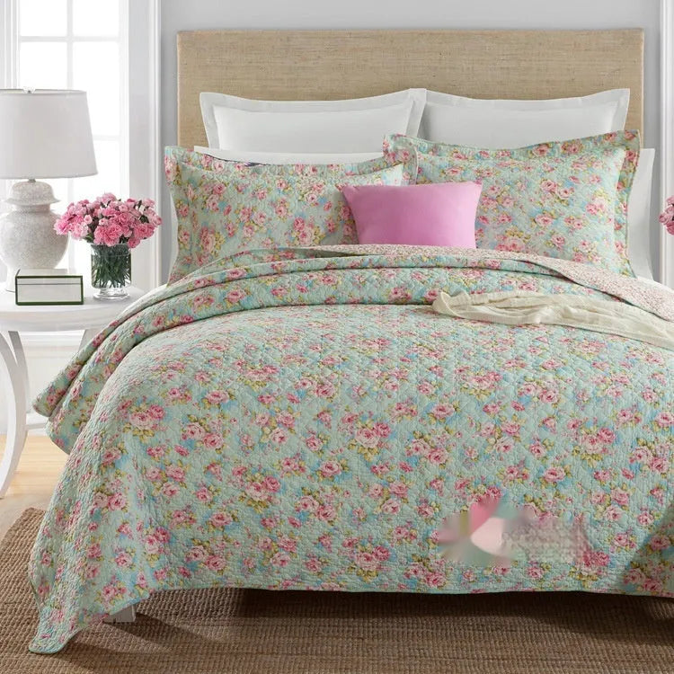 Quilted pure cotton bed cover set with printed pattern on a bed, includes two matching pillowcases.