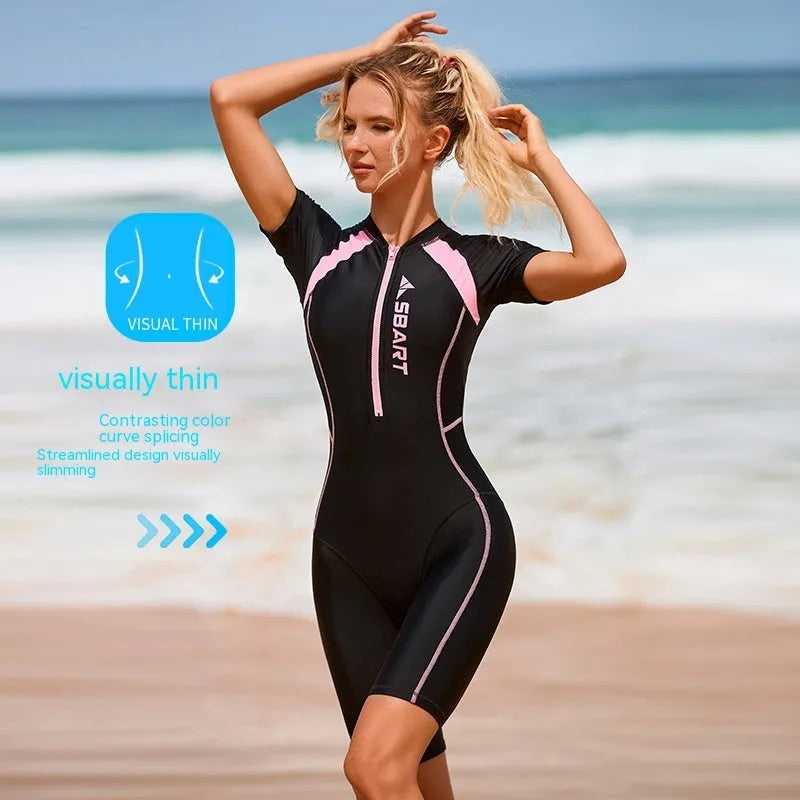 Solid colour women's one-piece swimsuit with short sleeves and built-in chest pads for surfing.